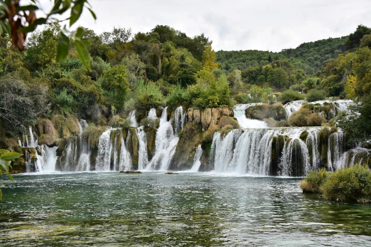 Captivating waterfall in Krka National Park, Croatia, showcasing nature's beauty amidst lush greenery.